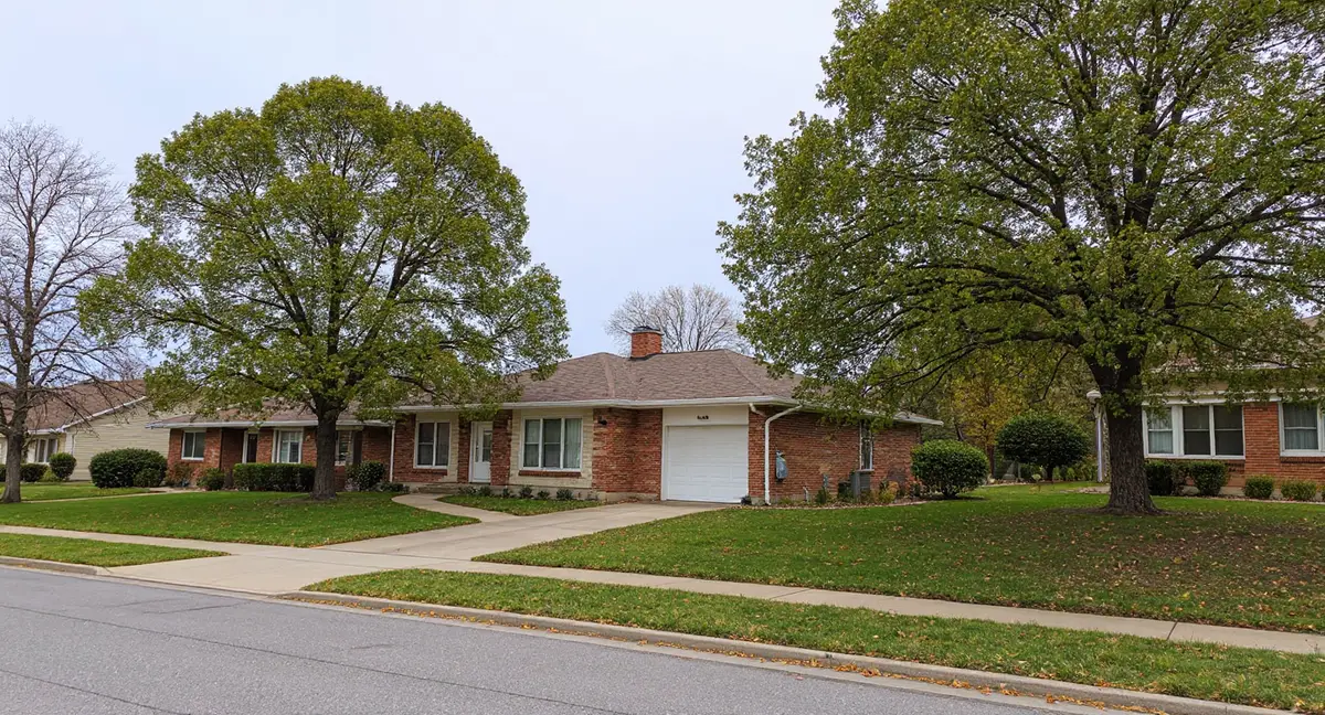 Residential street in Overland Park, Kansas showing mature landscaping and ranch-style homes typical of the northern development area built in the 1950s-1960s on Wymore-Ladoga clay soil