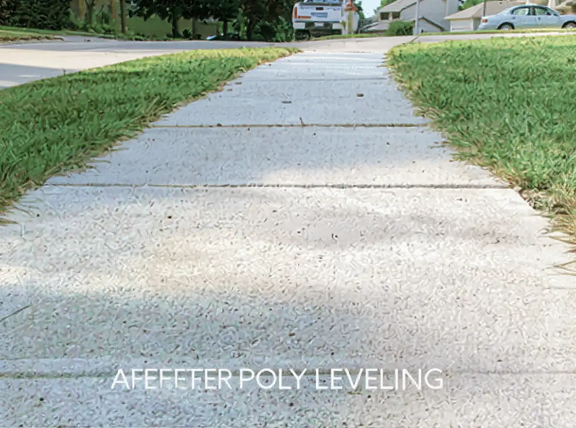 Completed polyjacking repair on a residential sidewalk showing small filled injection holes as the only visible evidence of the leveling work