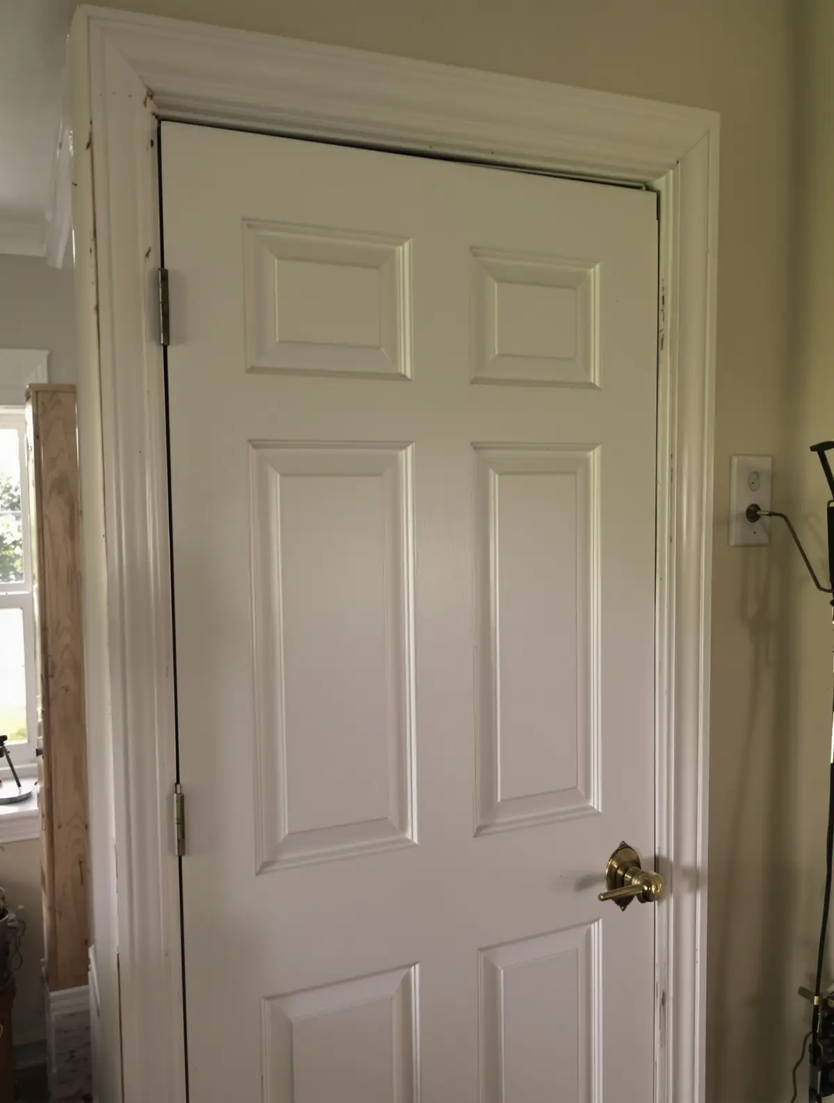 Interior door frame showing uneven gaps at top corners and visible distortion from foundation settlement causing the structural frame to rack out of square, a common symptom in Kansas City homes on expansive Wymore-Ladoga clay